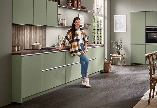 Person holding a tablet with the Nobilia dealer search open, showing a map full of location markers.