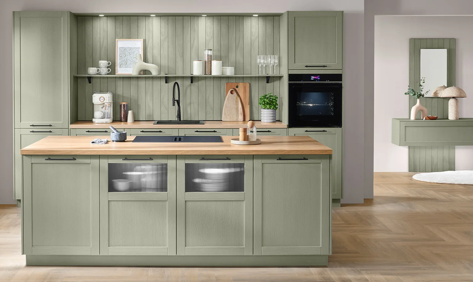 Modern country house kitchen in olive with framed fronts and natural charm.